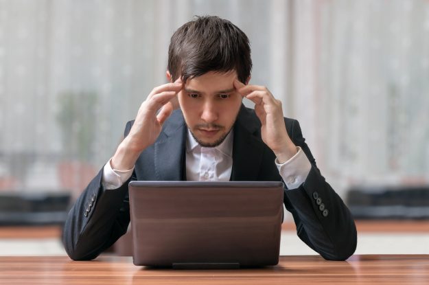 Young intend and thinking businessman working with laptop.